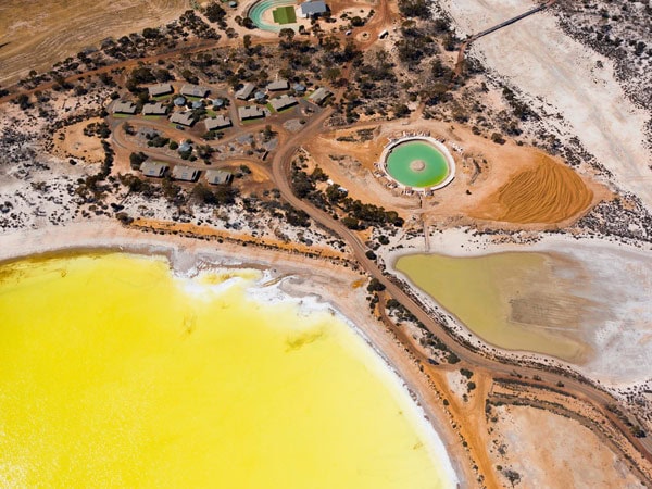 the luminous yellow water at Lake Magic as seen from above