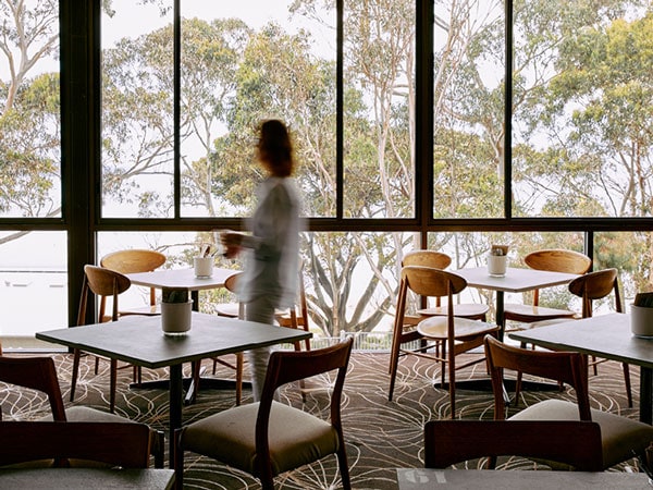 a woman walking inside The Lorne Hotel Bistro & Beer Garden