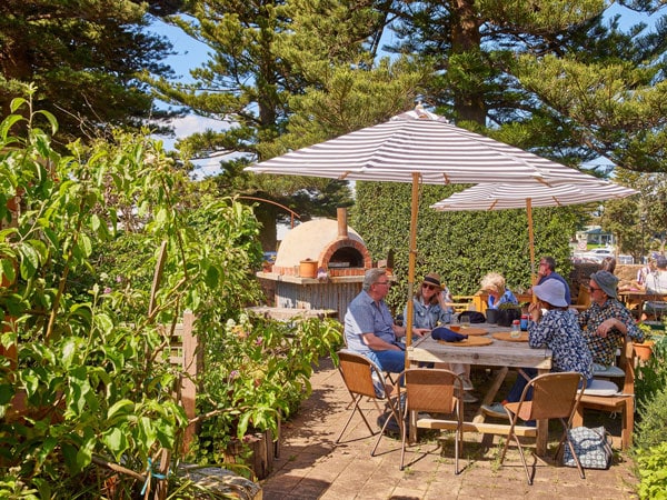 al fresco dining in a garden setting at Merrijig Kitchen, Port Fairy