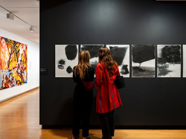 two women admiring paintings at the QUT Art Museum in Brisbane