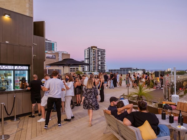 the AGWA Rooftop bar full of people at sunset