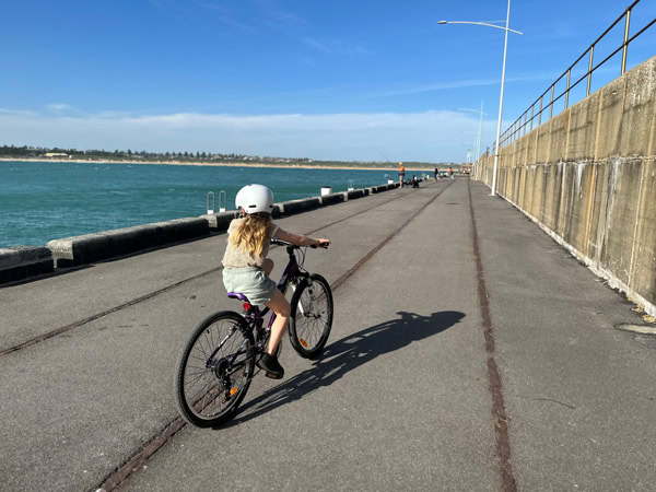 a little girl biking on the scenic Warrnambool