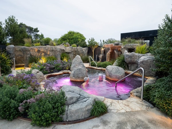 an old lady dipping in Deep Blue Hot Springs, Warrnambool