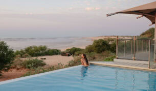 woman swims in the infinity pool at Eco Beach Resort Broome