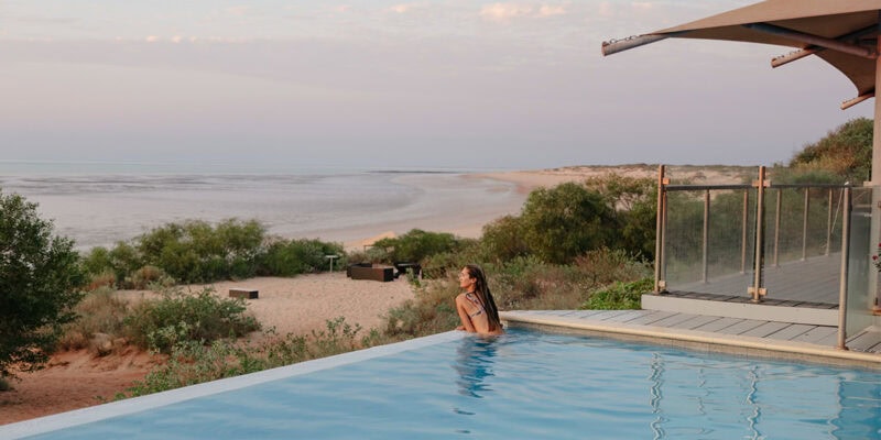 woman swims in the infinity pool at Eco Beach Resort Broome