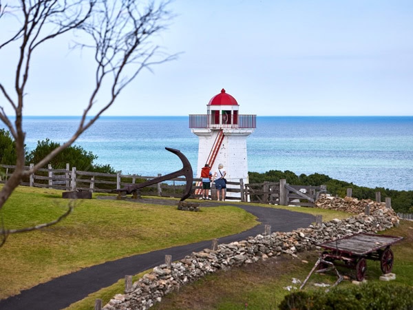 two people standing outside the the lighthouse at Flagstaff Hill Maritime Village lighthouse