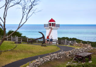 two people standing outside the lighthouse at Flagstaff Hill Maritime Village lighthouse