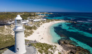 The Bathurst Lighthouse, crystal clear blue water and white sand.