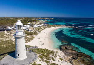 The Bathurst Lighthouse, crystal clear blue water and white sand.