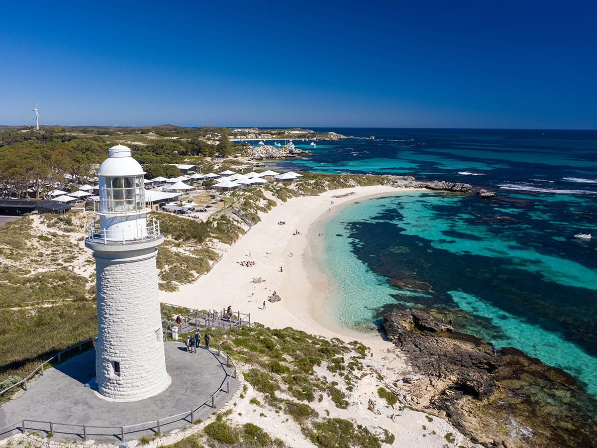 The Bathurst Lighthouse, crystal clear blue water and white sand.