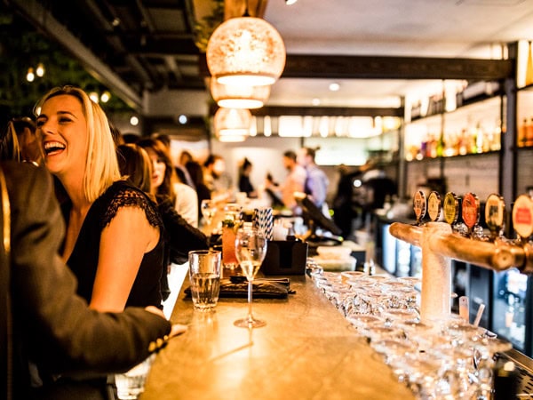 a woman smiling while having drinks at Hadiqa, Perth