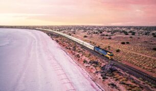 indian pacific train next to lake hart in south australia