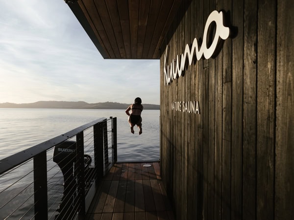 Person jumping into water from Kuuma Nature Sauna