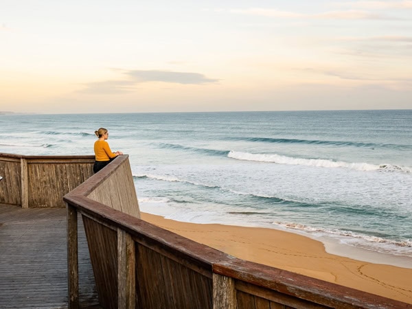 a woman soaking up the ocean breeze at Logan's Beach, Warrnambool