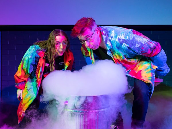 guests in colourful costumes blowing up steam at Questacon