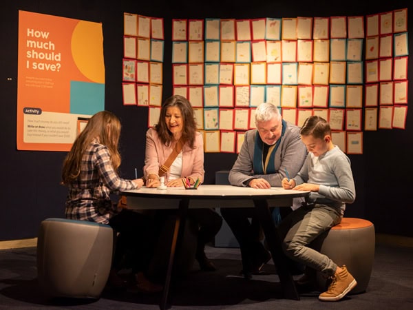 visitors sitting down inside The Royal Australian Mint, Canberra