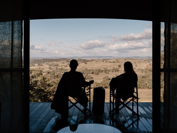 A man and woman enjoying the view on two chairs at Spicer Creek, Bundalong