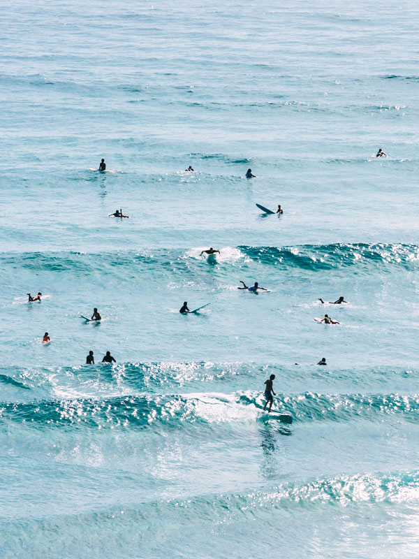 surfers hitting the waves