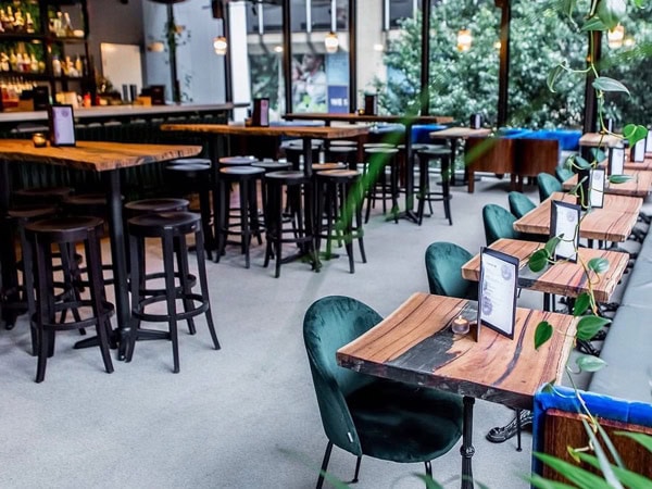 empty chairs and tables at the rooftop bar of Terrarium, Perth