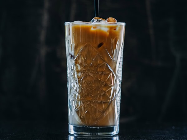 a glass of coffee in black background at Voodoo Cafe, Perth