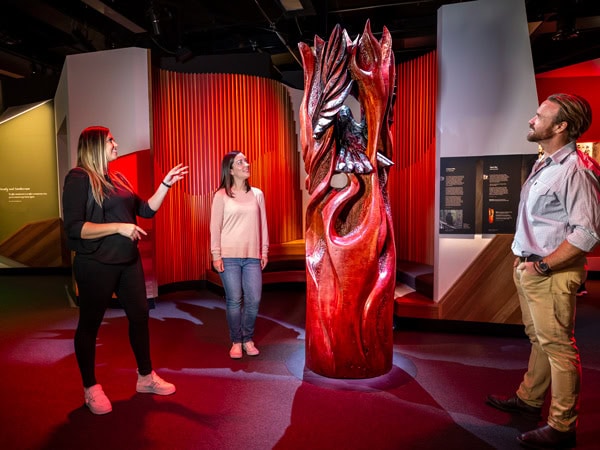 people admiring an Indigenous art at Bunjilaka Aboriginal Cultural Centre