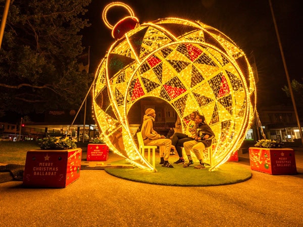 people sitting inside a huge Christmas ball in Ballarat