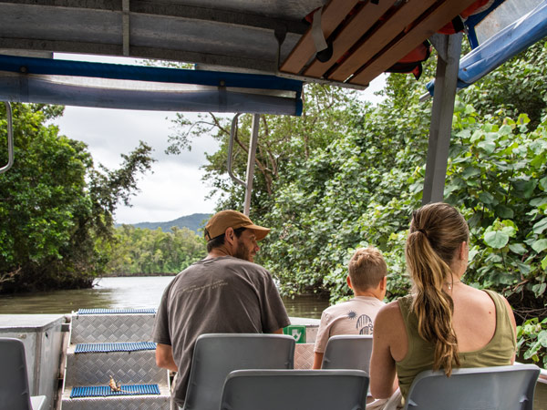 a family cruising the river with Daintree Discovery Tours
