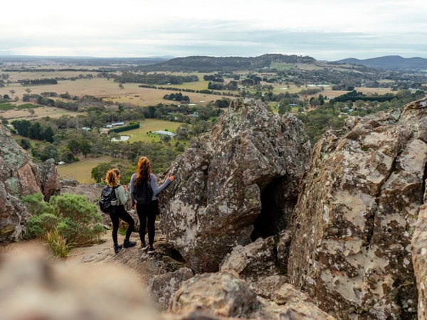 two people standing on top of the Hanging Rock