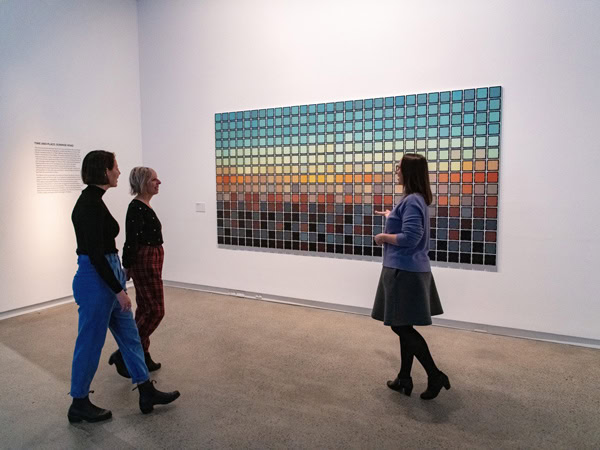 guests admiring an artwork on the wall at the Heide Museum of Modern Art