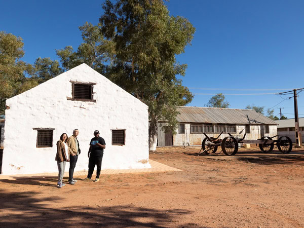 a couple exploring the Hermannsburg Historic Precinct with a local guide