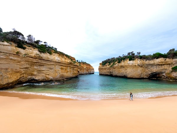 a beach with rock formations at Loch Ard Gorge