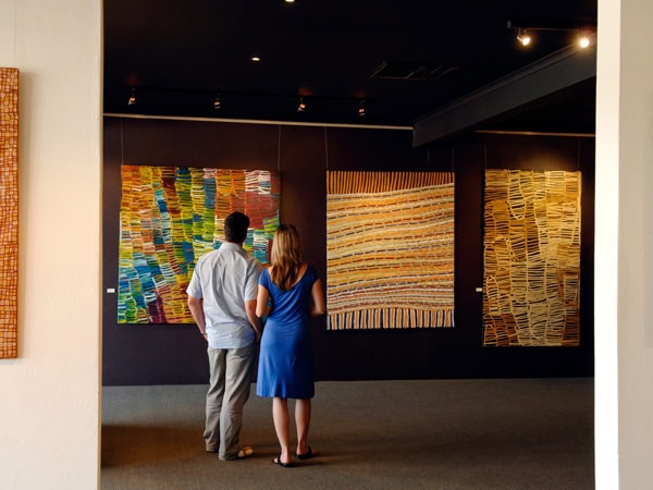 a couple admiring the artworks at Mbantua Gallery