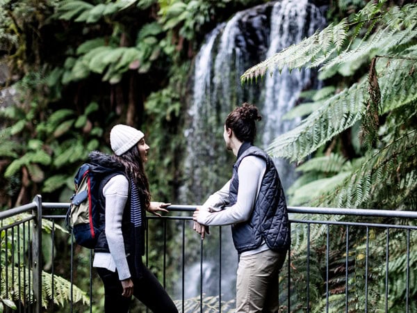 a couple admiring a cascade on the Great Ocean Road, Otway Eco Tours