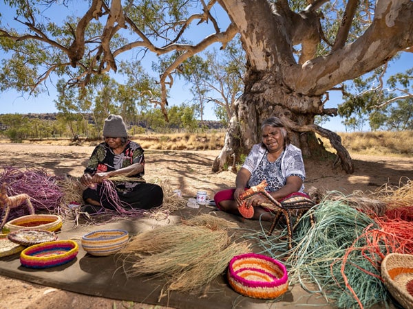 women weaving baskets, Tjanpi Desert Weavers