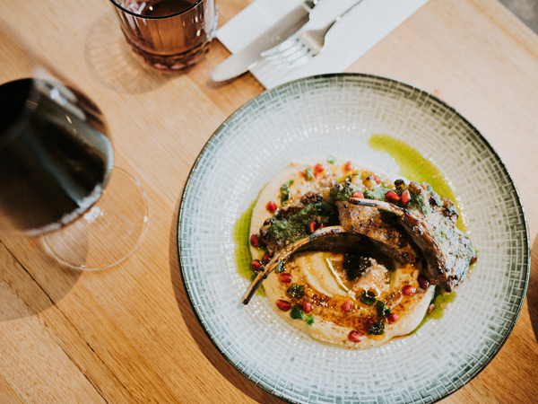 a table-top view of a dish alongside a glass of wine at Wayfinder Cellar Door and Restaurant