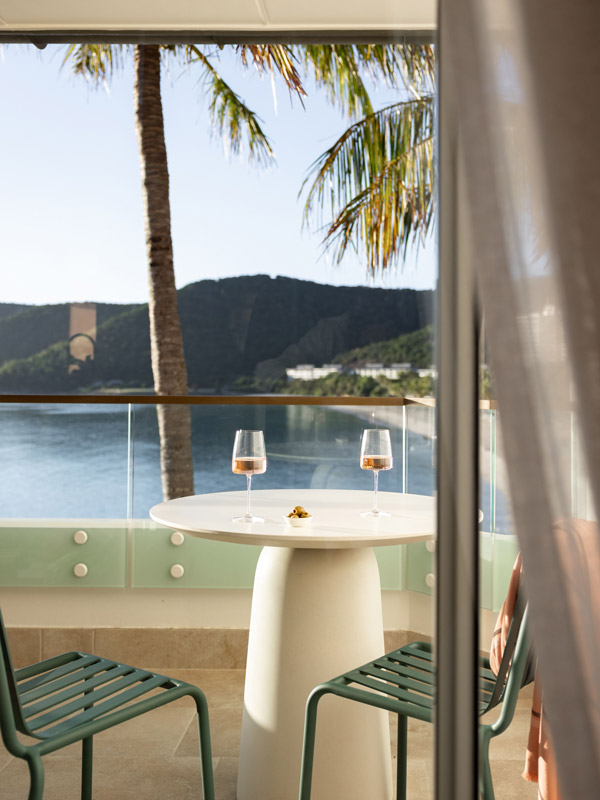 two wine glasses on the table of the suite's balcony at The Sundays, Hamilton Island