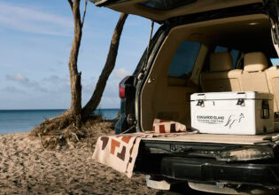 An esky in the back of a vehicle by the beach on tour with Kangaroo Island Touring Company.