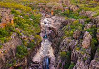 an aerial view of a waterfall in Kakadu