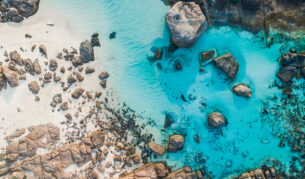 rocks dotting the clear blue waters of Boranup Beach