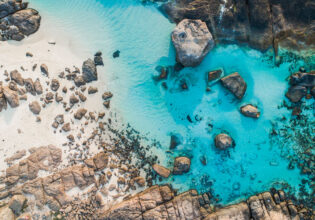 rocks dotting the clear blue waters of Boranup Beach