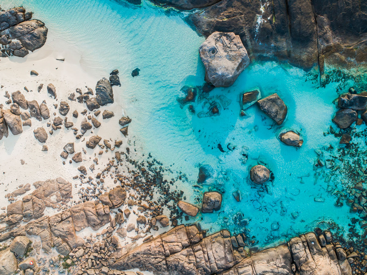 rocks dotting the clear blue waters of Boranup Beach