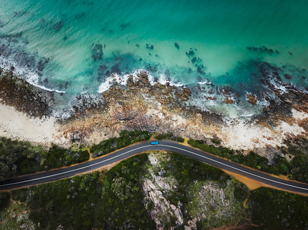 Aerial view of car driving alongside Eagle Bay Beach, Dunsborough