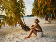 Woman deep in thought on an island beach