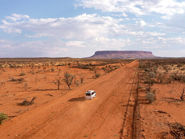 van driving towards mt connor in northern territory