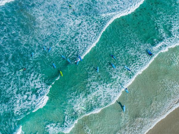 an aerial view of surfers at Redgate Beach, Margaret River