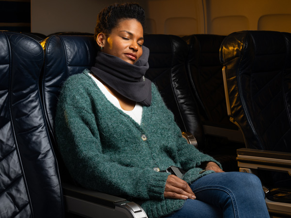 woman wearing Trtl travel pillow