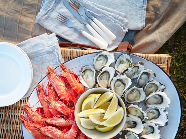 A seafood platter with oysters and prawns