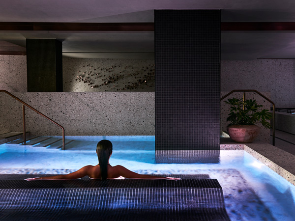 a woman bathing in a magnesium mineral pool at Aurora Spa & Bathhouse