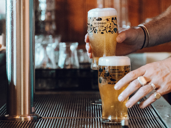 hand holding two glasses of beer at Bodriggy Brewing Company, Abbotsford