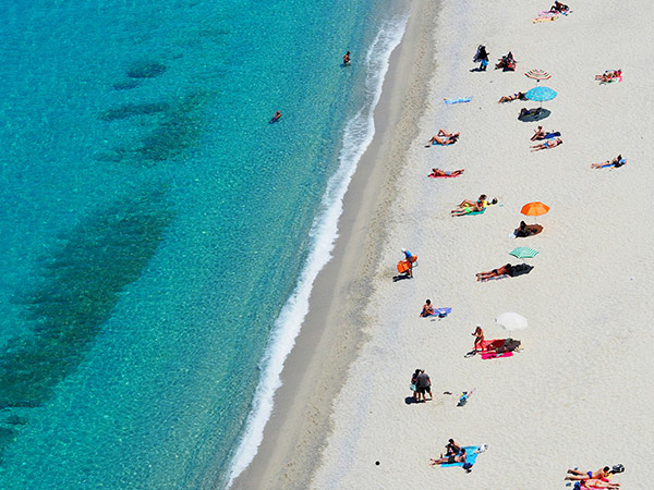 aerial view of people on white sand beach